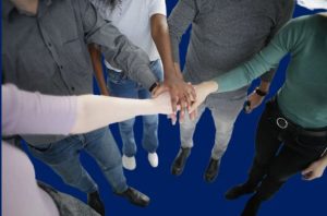 people of different races joining hands to choose JM Solutions Tech